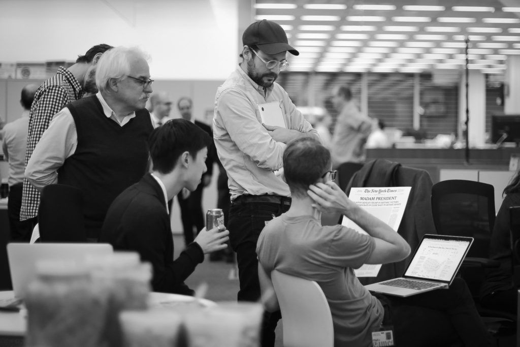 Tom Bodkin, left, looking over a mock-up of a possible front page for Wednesday’s New York Times. Credit Stephen Hiltner/The New York Times